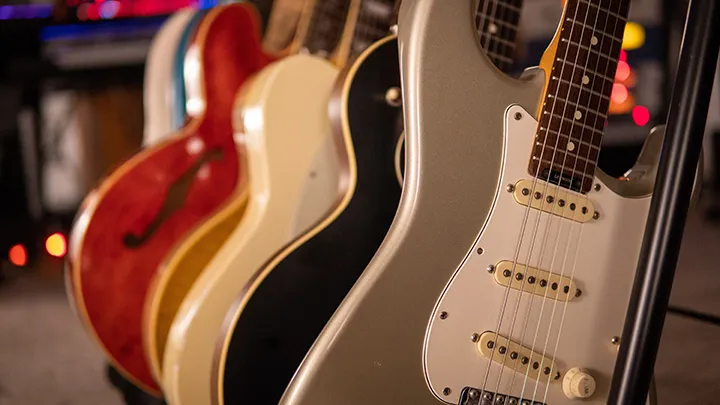 a variety of different guitars lined up